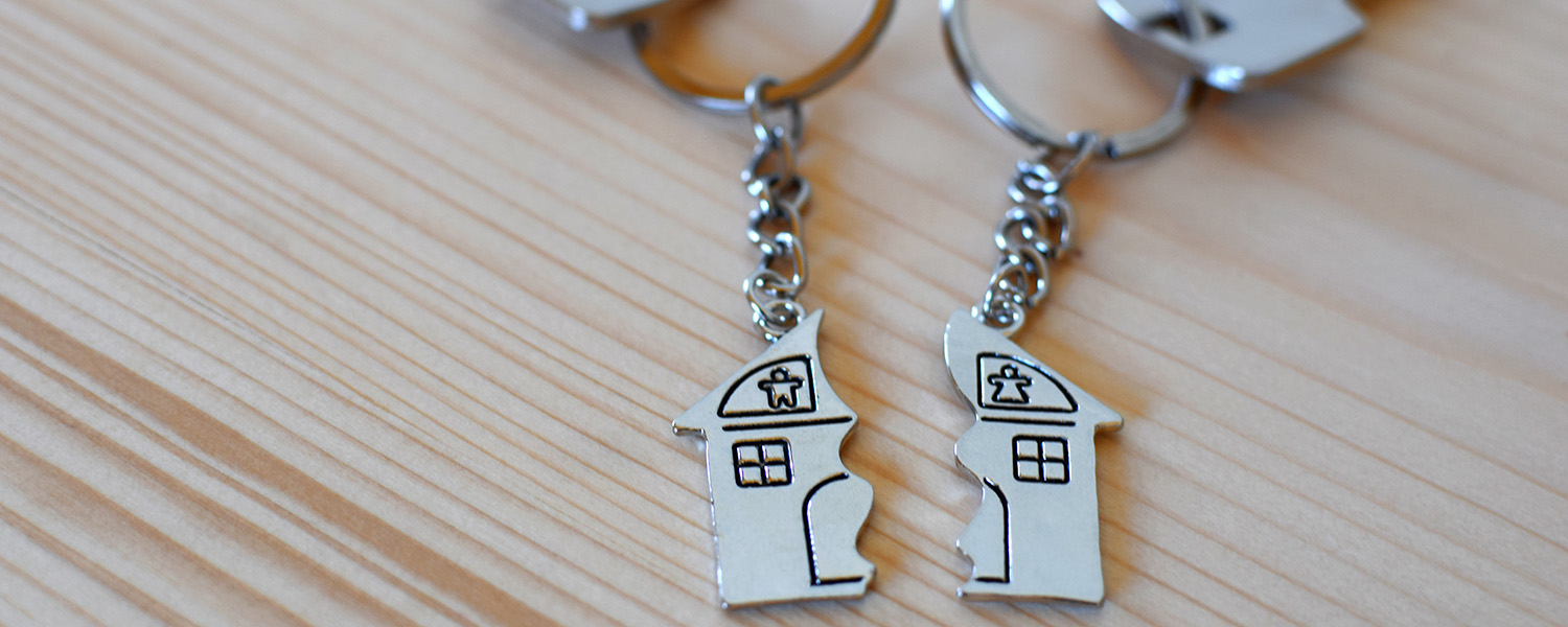two keyrings with a side of a house each