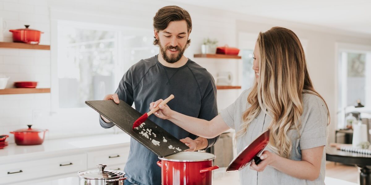 image of family cooking and signing documents relating to renting property to family members